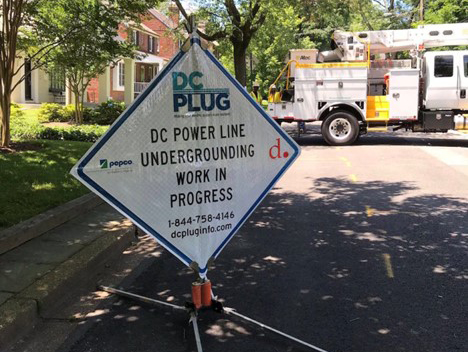 Work sign announcing DC PLUG work being performed in area.