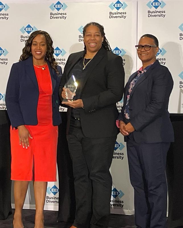 KDM Engineering President Kimberly Moore (center) accepts the EEI Diverse Business Award.