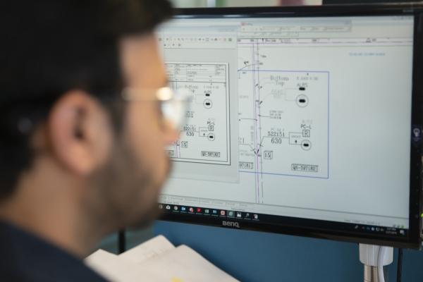 Engineer working on auto CAD program on computer