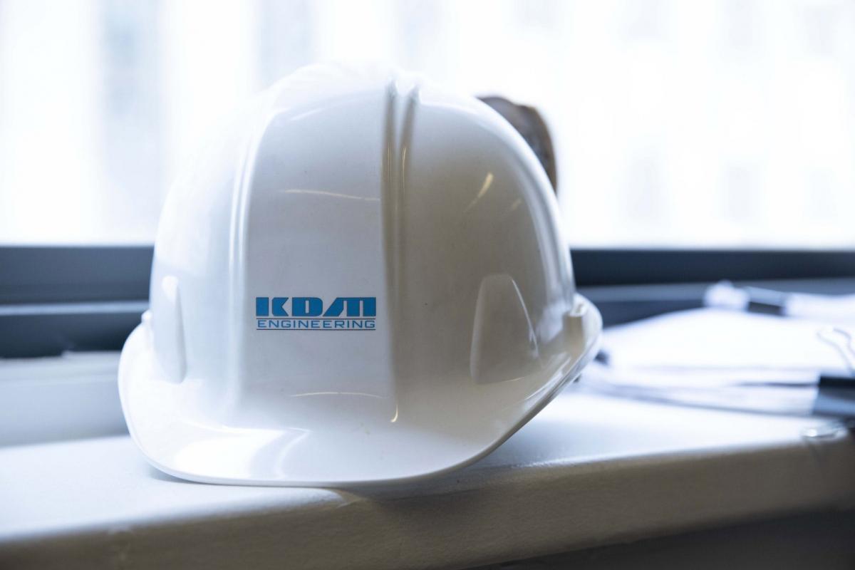 This KDM Engineering branded hard hat is issued to all KDM engineers to safely perform their work in the field.