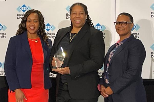KDM Engineering President Kimberly Moore (center) accepts the EEI Diverse Business Award.
