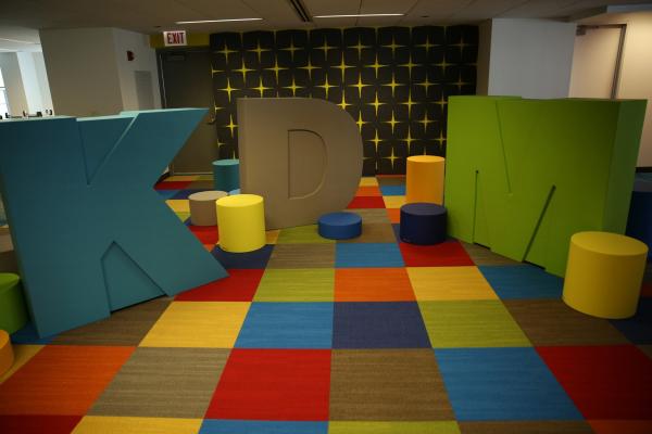 The KDM office offers many employee perks, including these fun, large and colorful KDM letters and seats that decorate an employee lounge area.
